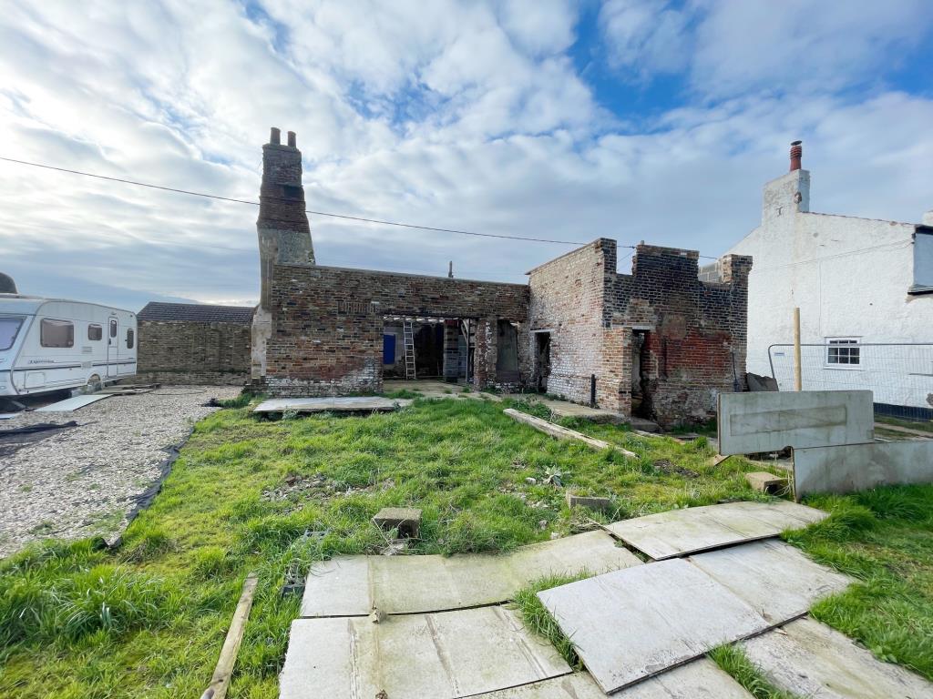Lot: 101 - COTTAGE RENOVATION PROJECT WITH PLANNING IN VILLAGE LOCATION - Rear view of the part-built cottage renovation
